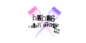 Crossed pink and purple paintbrushes on a black background.